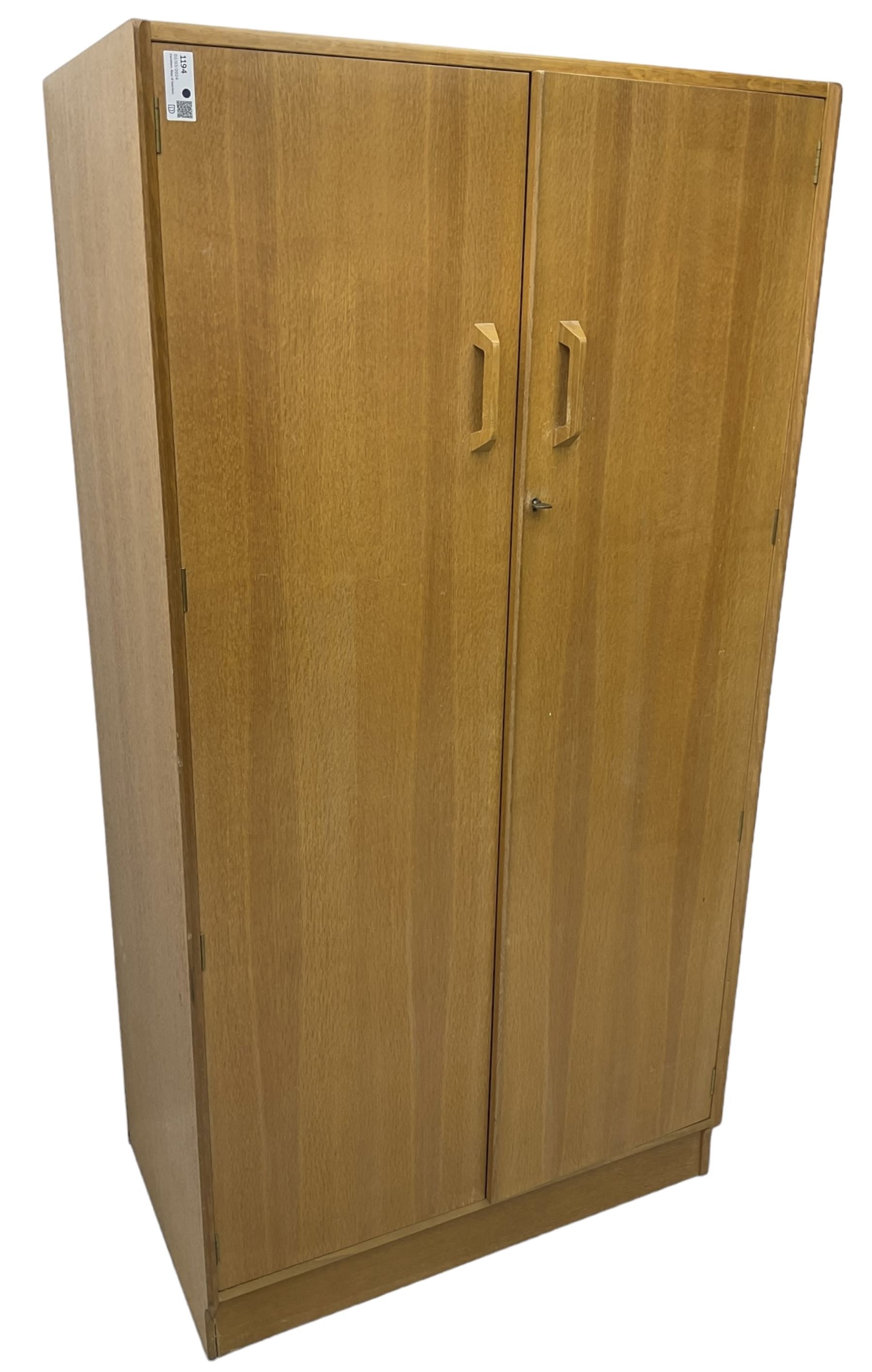 E. Gomme for G-Plan - 'Brandon' light oak double wardrobe, the interior fitted with hanging rail and shelves 