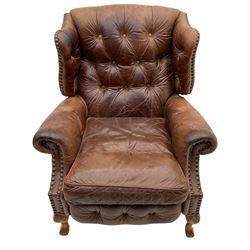Georgian style wing back reclining armchair, upholstered in buttoned and studded antique brown leather

