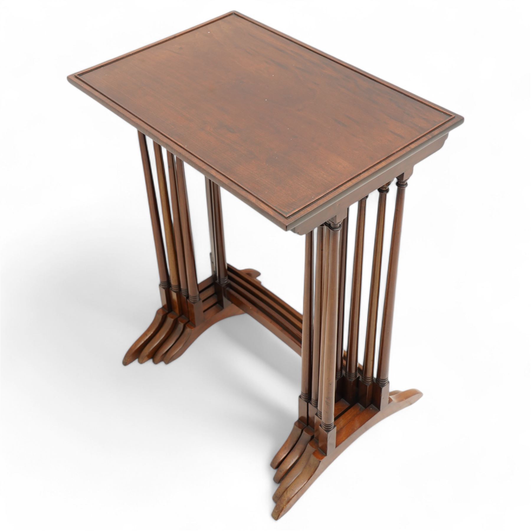 Early 20th century mahogany quartetto nest of four occasional tables, each with rectangular top with raised lip moulding, turned supports on splayed feet