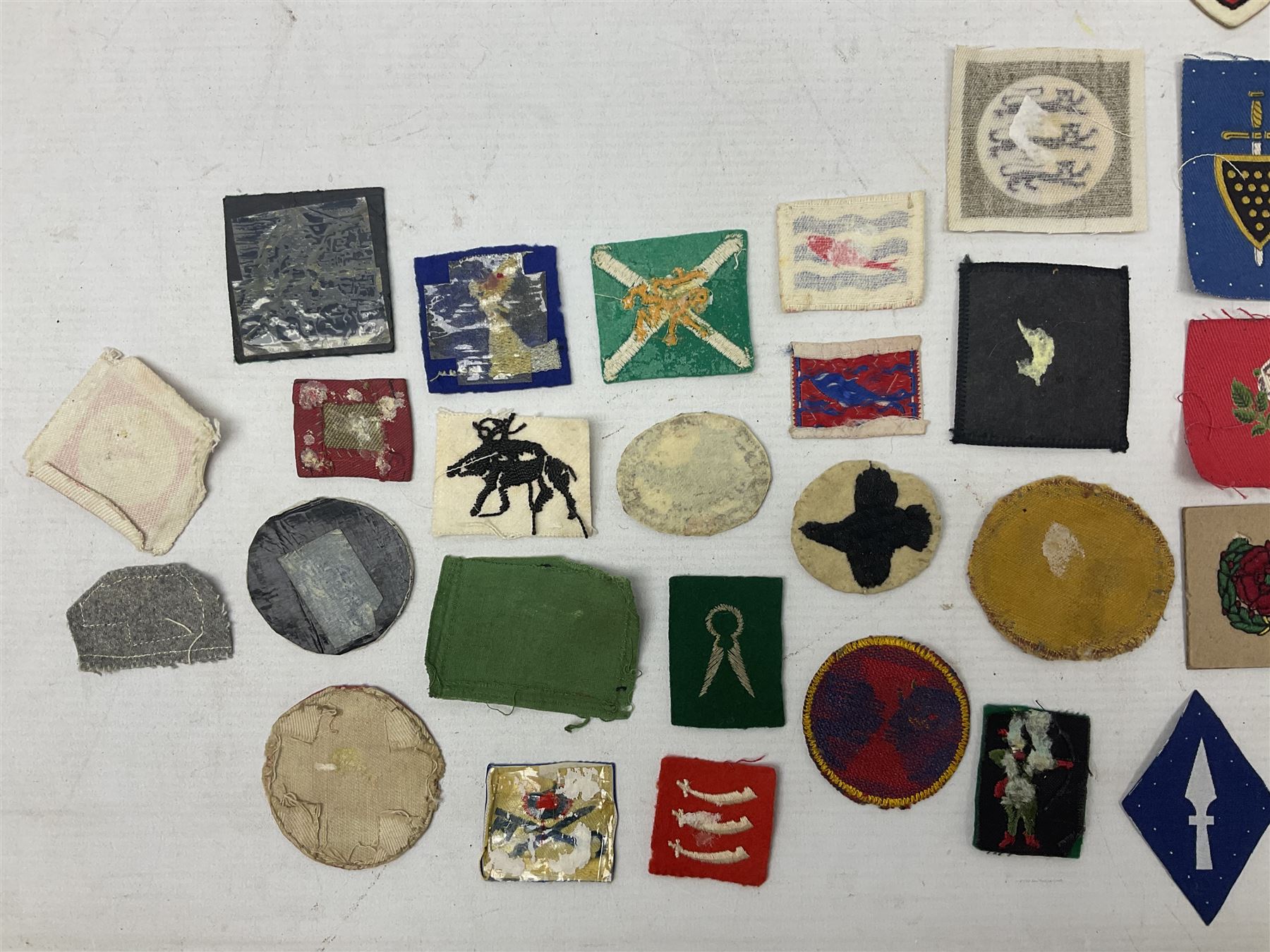 Approximately one-hundred printed and embroidered cloth badges including I, II, VIII, XI, XII and XXX Corps, Eastern Command, various Armoured Divisions, Midland, Wessex, Home Counties and 12th Infantry Brigades, Salisbury Plain, Northumberland, Hampshire, North Midland, West Riding, Essex and Suffolk Districts, Berlin & Rhine Army Troops etc