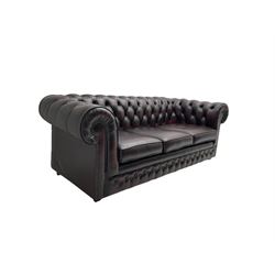 Thomas Lloyd - three seat Chesterfield sofa, upholstered in buttoned oxblood leather, on castors 