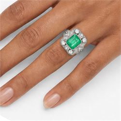 Platinum emerald and diamond cluster ring, single octagonal cut emerald of 2.52 carat, surrounded by milgrain set round brilliant cut and single cut diamonds, stamped PT950, total diamond weight 0.82 carat