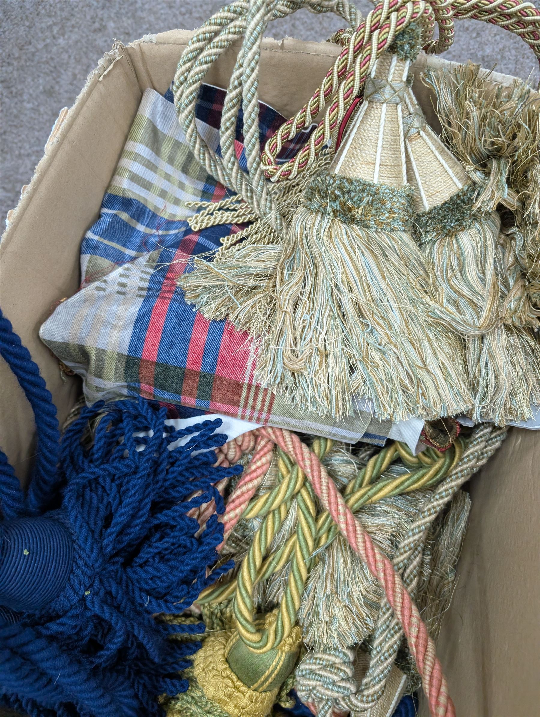 Collection of curtain fabric pieces and tassels