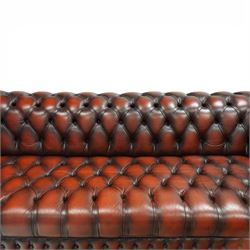 Late 20th century four seat Chesterfield sofa, upholstered in deep buttoned brown leather, with rolled arms, buttoned back and seat, studded detailing and squat feet