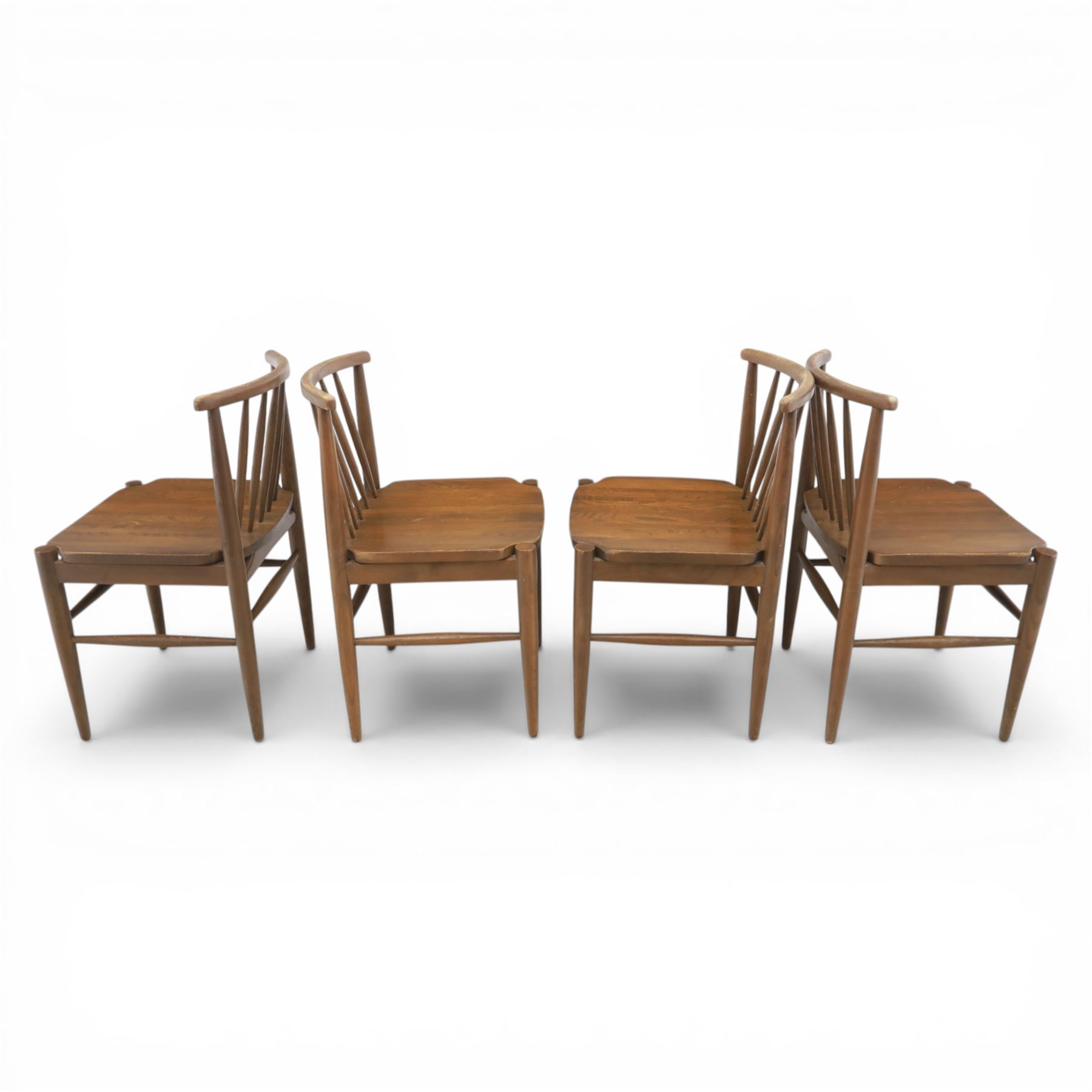 Ensign - Mid-20th century elm extending dining table, with fold out leaf, bow ends and sides; and four low stick back chairs, labelled Ensign Bristow & Townsend Ltd, extended 168cm