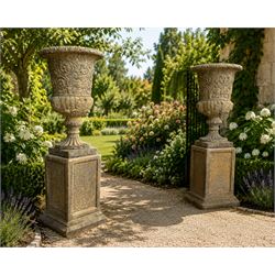 Pair of George III design antiqued composite stone garden urns of campana form, the egg-an...