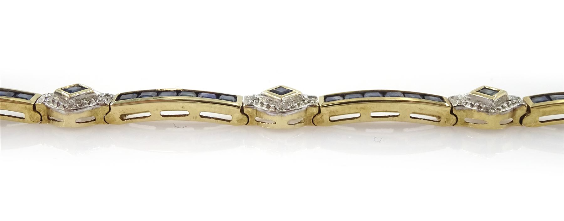 9ct gold sapphire and diamond bracelet, nine square cut sapphire and diamond chip clusters, each spaced by six channel set sapphire links, hallmarked
