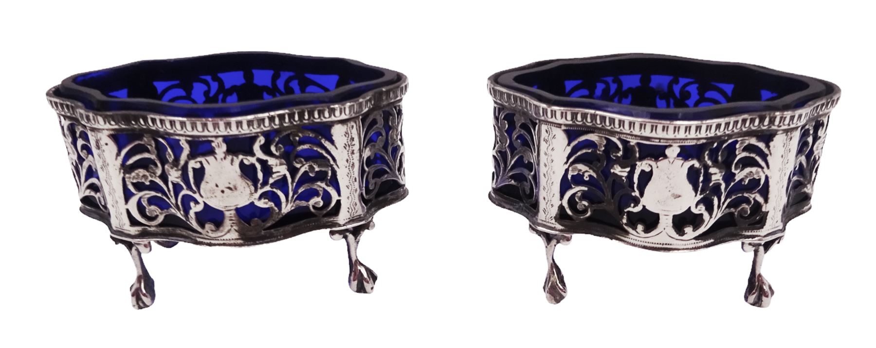 Pair of Victorian open silver salts with pierced sides, upon four ball and claw feet, hallmarked George Nathan & Ridley Hayes, Chester 1900, H5.2cm, each with blue glass liner