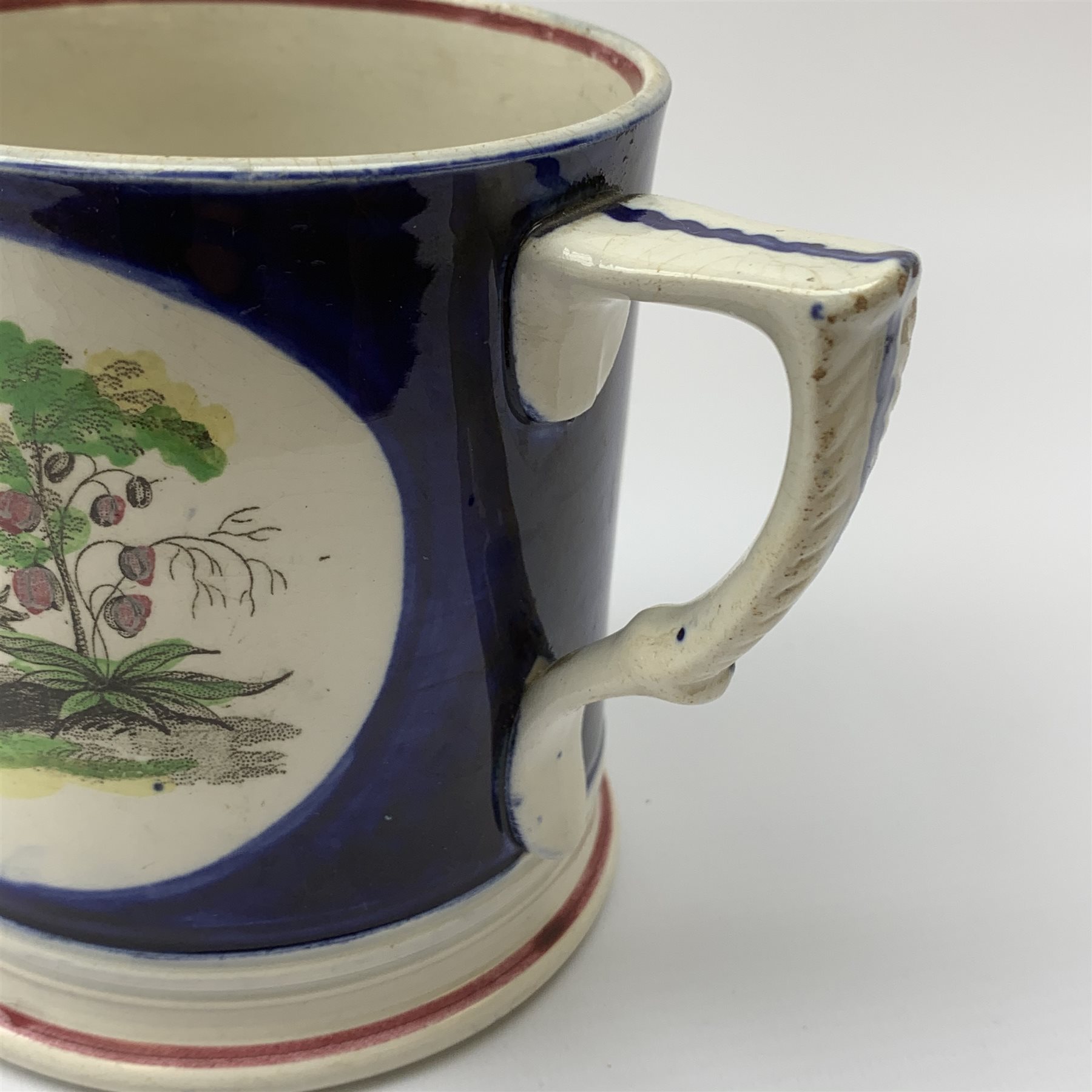 An early Victorian earthenware frog or surprise mug, decorated with printed and overpainted figural panels, H11cm, together with a 19th century child's plate detailed with a figural scene and inscribed Father Matthew administering the total abstinence pledge, 17.5cm, and a Staffordshire flat back figure seated upon a horse, H33cm. 