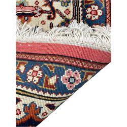 Large Persian carpet, the geometric and stylised floral medallion on rust ground field decorated with stylised plant motifs, guarded ivory border with repeating pattern