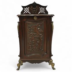 Late Victorian mahogany coal purdonium, the serpentine front door carved with scrolling foliage, surmounted by a pierced and foliate crest, brass carrying handles to sides, gilt metal mounts and cabriole legs