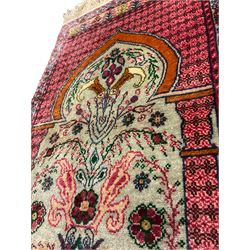 Small Persian magenta ground rug, central Mirab with flanking columns enclosing stylised urn motif with trailing foliage, the triple band border with plant motifs (86cm x 46cm); Persian red ground rug, two central floral medallions with extending flower heads, floral decorated border (106cm x 53cm) (2)