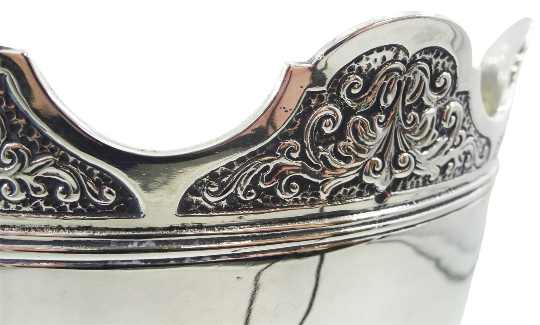 Late Edwardian silver Monteith bowl, the plain body with moulded foliate detailed and shaped rim, upon a circular stepped foot, hallmarked Selfridge & Co Ltd, London 1908, H17cm D21.5cm, approximate weight 31.64 ozt (984.4 grams)

