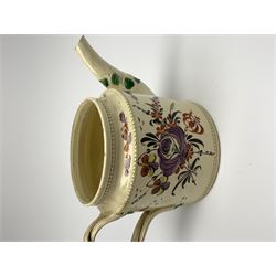 18th century creamware teapot, probably Leeds, with reeded entwined handle and floral finial to the cover, the body with hand painted polychrome decoration of figure to one side, and floral spray to the other, collectors paper label beneath inscribed Leeds Pottery, H11.5cm
