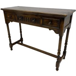 Medium oak side table, rectangular top over three drawers, on turned supports united by H-shaped stretcher rails 