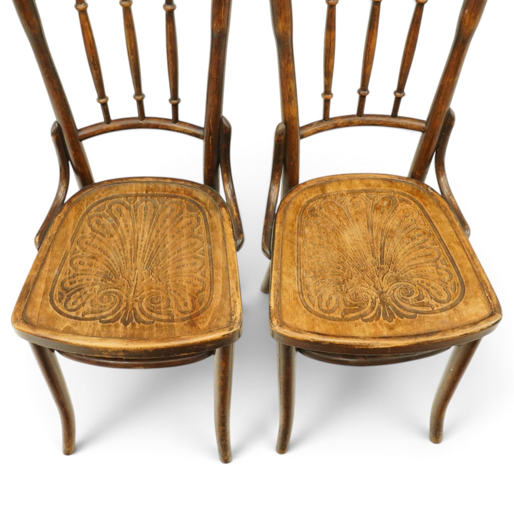 Thonet - pair of early 20th century bentwood bistro side chairs, spindle backs over anthemion motif seats, on tapering supports