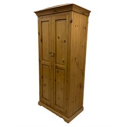 Solid pine double wardrobe, fitted with two panelled doors