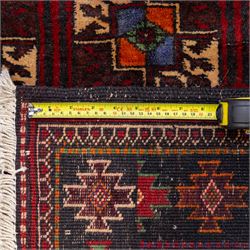 Tekke Bohara hand-knotted rug, madder red field decorated with an all-over design of repeating octagonal guls and latch-hook motifs within multiple geometric borders and cotton fringe ends 