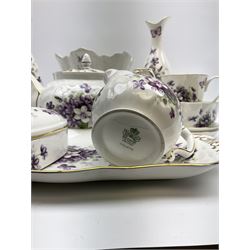  A group of Aynsley Wild Violet pattern china, comprising teapot, two cups, milk jug, two small bowls/open sucriers, sandwich plate, three small pin dishes, lidded trinket box, and planter. 