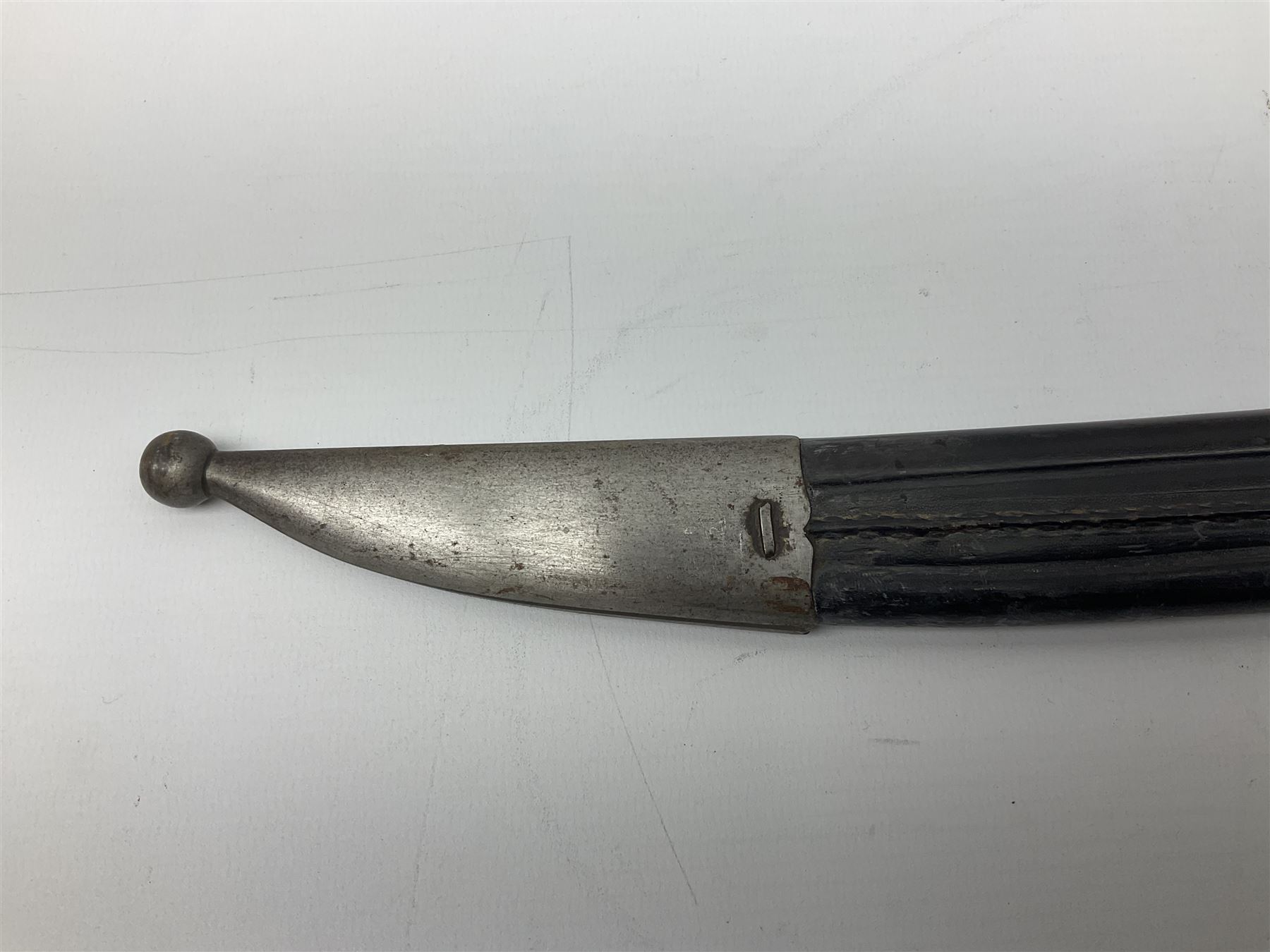 Turkish Model 1874 sword bayonet with 57.5cm curving steel fullered blade and chequered black grip, in steel mounted leather scabbard L75.5cm overall