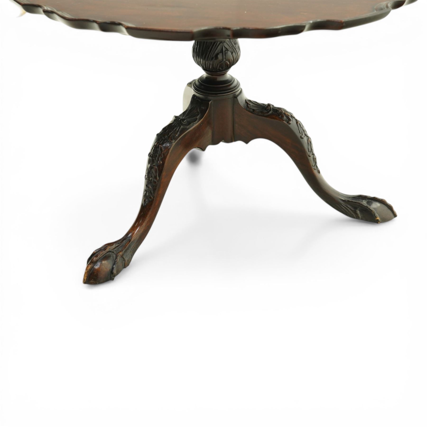 Late 19th century mahogany piecrust occasional table, circular top with scalloped moulded edge, on a turned pedestal with carved cabriole supports terminating in claw and ball feet