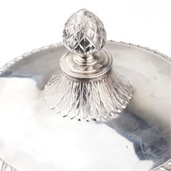 George III silver two handled campana shape cup and cover with pineapple lift, the body with cartouche surrounded by flowers above leaves and scrolls on a pedestal foot with acanthus leaf decoration H29cm London 1764, makers marks rubbed