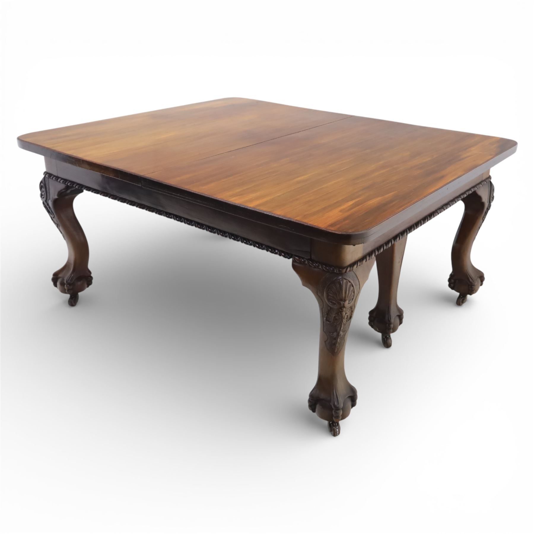 19th century mahogany extending dining table and eight chairs, rectangular top with rounded corners and additional leaves, plain frieze with carved gadrooned edge detail, raised on cabriole supports terminating in ball and claw feet, together with a set of eight mahogany dining chairs including two carvers, the chairs with curved top rails and pierced splats, upholstered drop-in seats, on turned supports

(Table extends to 312cm)