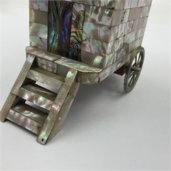 19th century French souvenir jewellery casket in the form of a bathing machine, having mother of pearl panelled tiled effect body, hinged roof/cover revealing a blue silk fitted interior with cushioned base, two silvered metal wheels, abalone shell door and mother of pearl steps, inscribed 'Berck Plage' in blue, H12cm, W13cm 