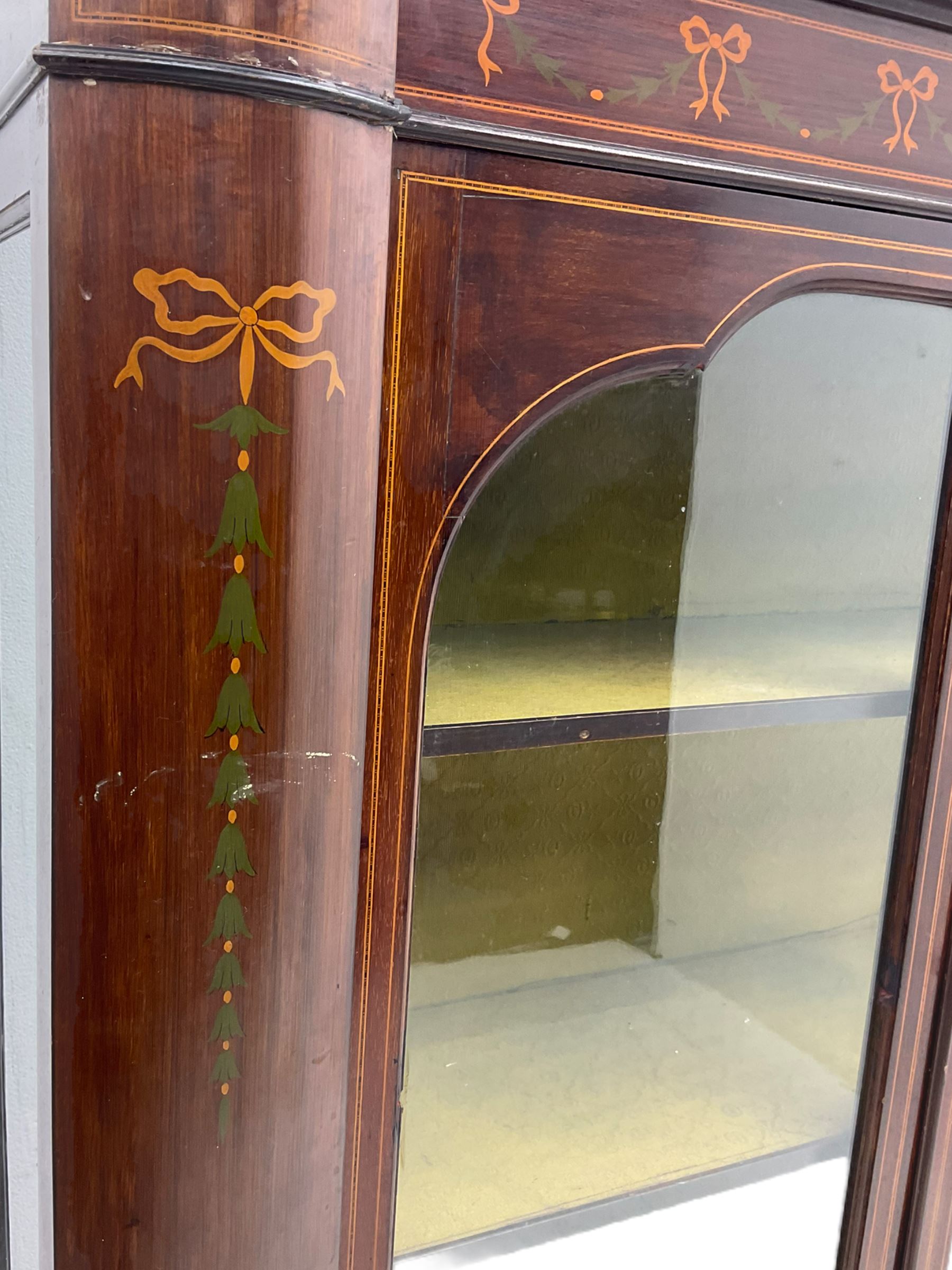 Edwardian mahogany display cabinet, shaped front with painted ribbon and bellflower garland decoration, enclosed by two glazed doors, cabriole supports