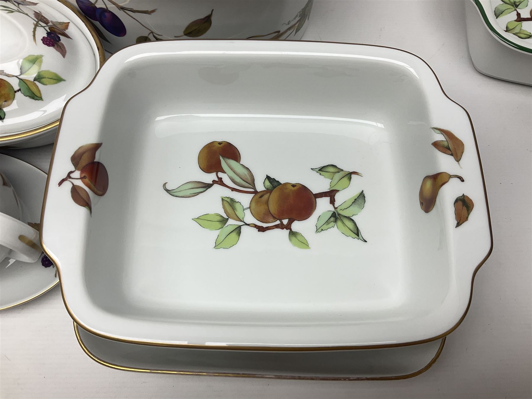 Royal Worcester Evesham pattern, including covered pot de cremes, twin handle tureen, serving dishes, flan dishes, side plates etc  