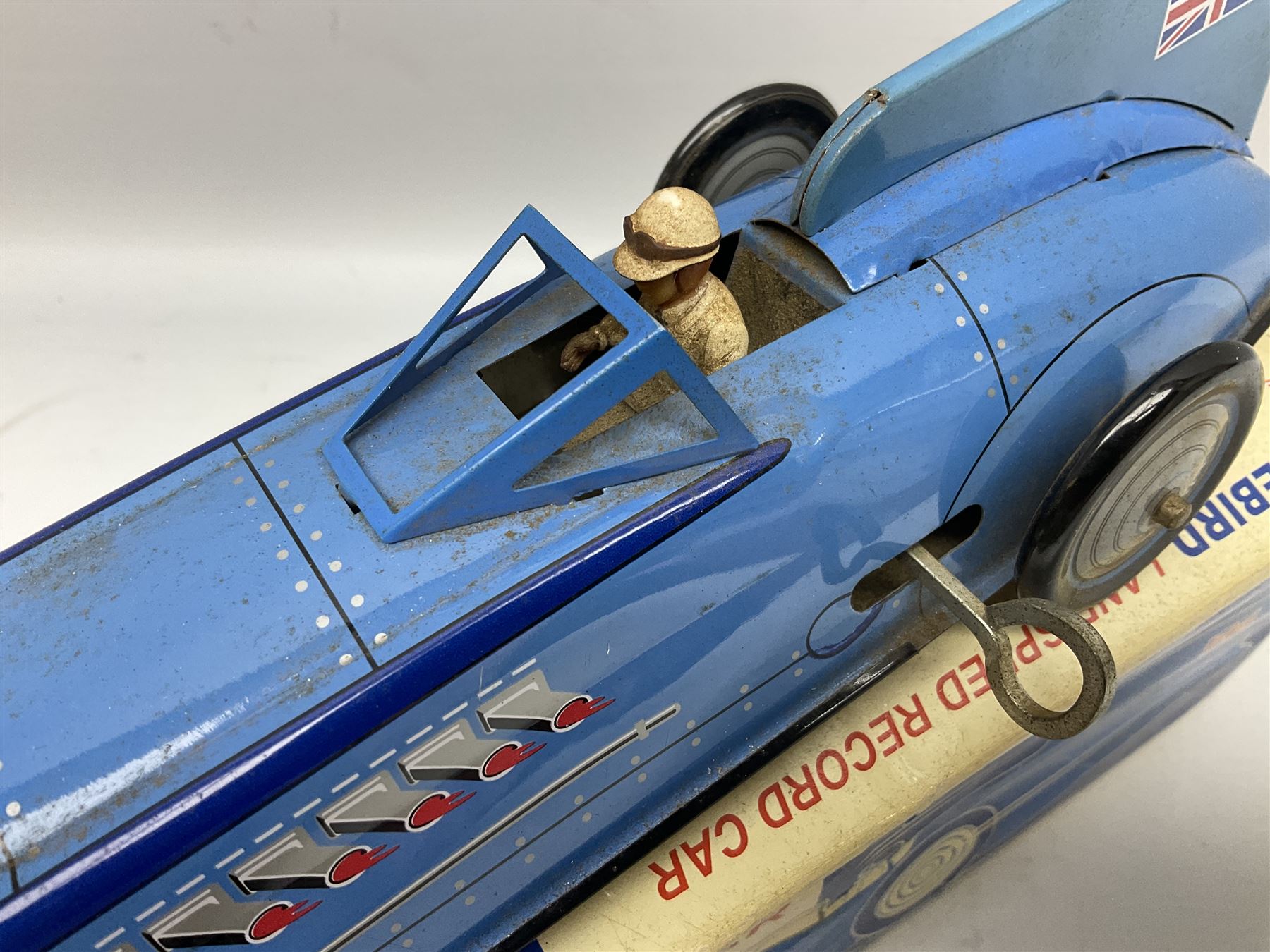 Schylling Collector Series clockwork tin-plate Sir Ian's Bluebird Land Speed Record Car with key and paperwork No.006080; boxed; and clockwork silvered tin-plate model of an 0-6-0 locomotive; unboxed (2)