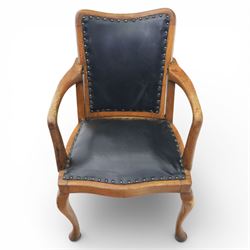 20th century oak recliner armchair, the curved back upholstered in leather with brass stud edging, hinged reclining back operated by side ratchet fittings, leather upholstered seat, shaped open arms, raised on cabriole legs