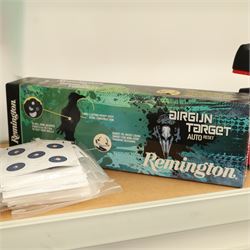 Air gun accessories; Remington Auto Reset crow target, MCM “Predator” shooting rest, paper target holder mounted to a target with additional paper targets