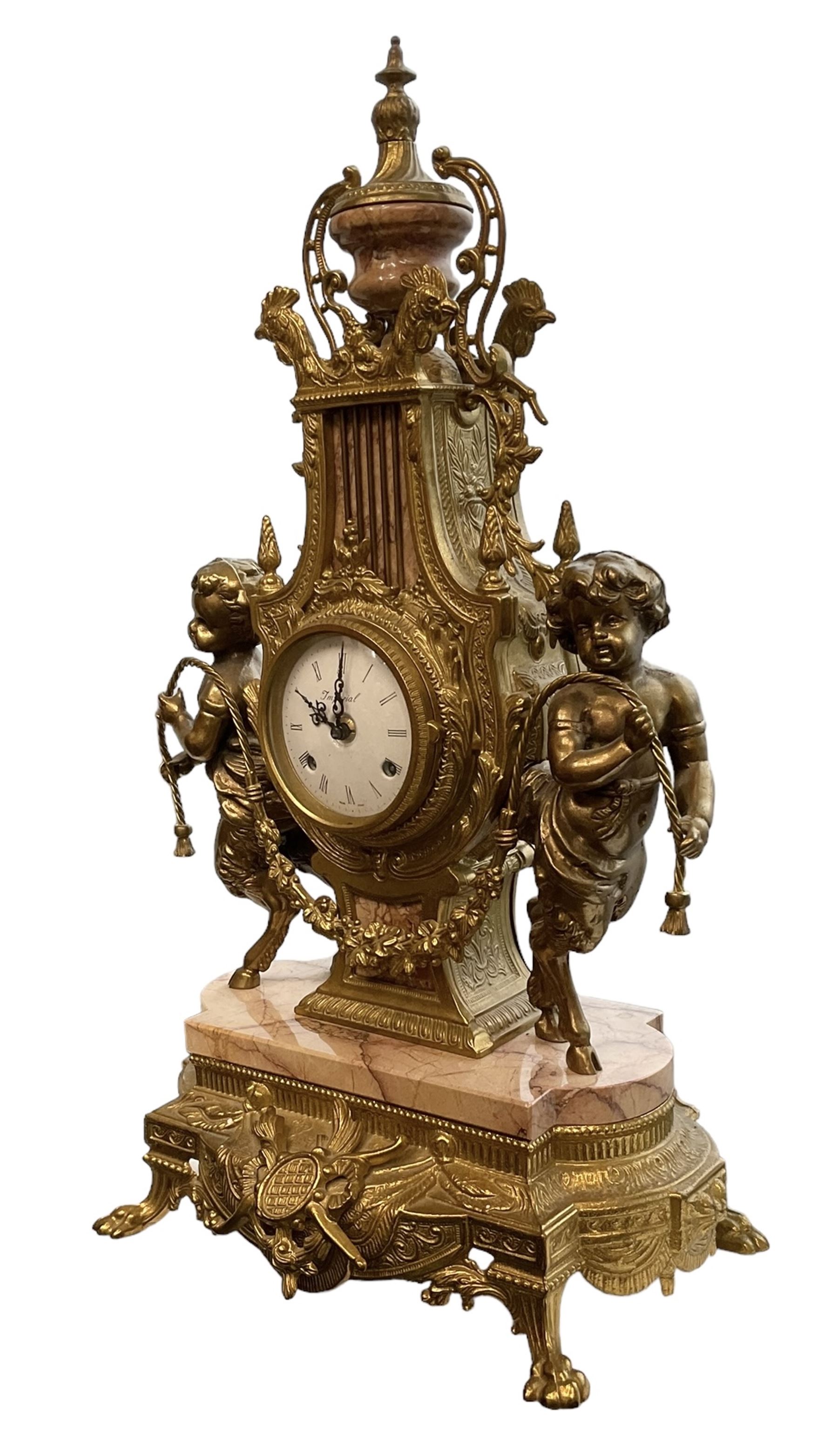 Imperial - 20th century continental 8-day brass and marble mantle clock, with an enamel dial, Roman numerals and pierced gilt hands, twin train striking movement sounding the hours and half hours on two bells, with a floating balance escapement.  With key.