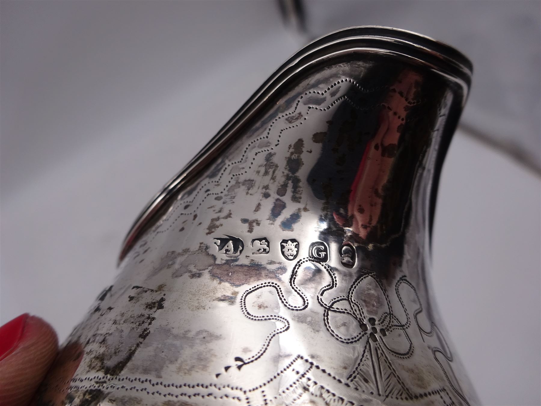George III silver cream jug, of helmet form, with C scroll handle and a band of engraved strapwork decoration and monogrammed initials to body, hallmarked London 1802, maker's mark SA probably Stephen Adams I, including handle H10.4cm