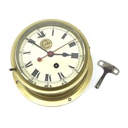 Ship's brass cased bulkhead clock by Cooke Hull with eight-day movement, the circular dial with Roman numerals, sweep seconds hand and gilt sunburst logo D20cm