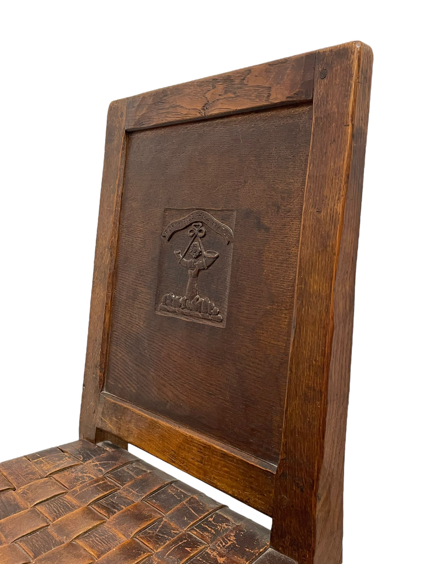 Mouseman - circa. 1930s set of six (4+2) oak dining chairs, panelled back carved with the Bagshawe family crest, the moto 'Forma Flos Fama Flatus' over an arm grasping a bugle-horn with ribbon tie and Yorkshire rose motif, adzed frame, leather lattice strap seat, on octagonal supports united by stretchers, two carvers and four side chairs, each carved with mouse signature, by Robert Thompson of Kilburn 

Provenance: Owned since manufacture by the Bagshawe family, descendants of the Staithes Group Artist Joseph Richard Bagshawe RBA (1870-1909).