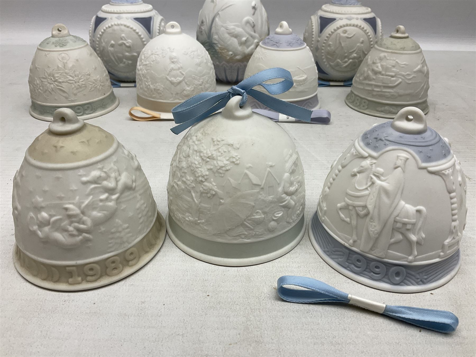 Seven Lladro bells, comprising Summer no 17614, Fall 17615, Christmas 1988 no 5525, Christmas 1989 no 5616,  Christmas 1990 no 5641, Christmas 1992 no 15913 and Christmas 1993 no 16010, together with two Lladro Christmas balls no 1603 and Lladro easter eggs 1994 no 17532