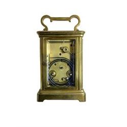 W.R. Cullen, London Street. Norwich. - 8-day French carriage clock c1900, in a corniche case with carrying handle and four bevelled glass panels, white enamel dial with Roman numerals, minute markers and spade hands, with a lever platform escapement and rack striking movement striking the hours and half hours on a coiled gong. 