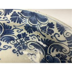 Early 18th century Delft marriage plate, of circular form with dished centre, the centre inscribed and dated 'Thomas and Elizabeth Kockerill Bridlington Key 1715' within a crowned C scroll cartouche, flanked by demi-griffins, above a putto head and tassels, within a wide foliate border, D34cm
