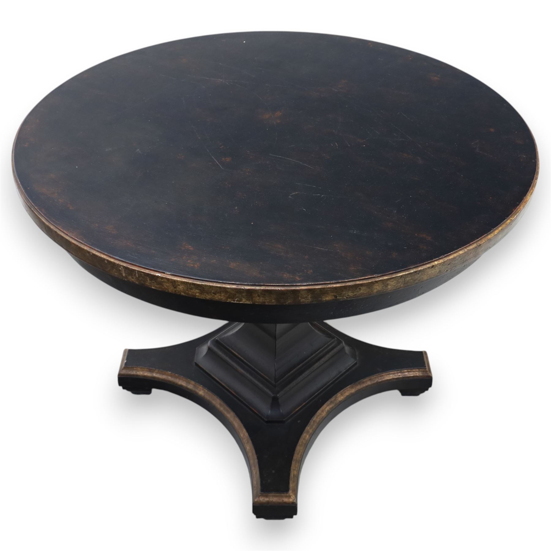 Contemporary circular painted dining table and four red upholstered chairs, table with distressed finish in black with quatriform base and bronze painted edges, chairs with 