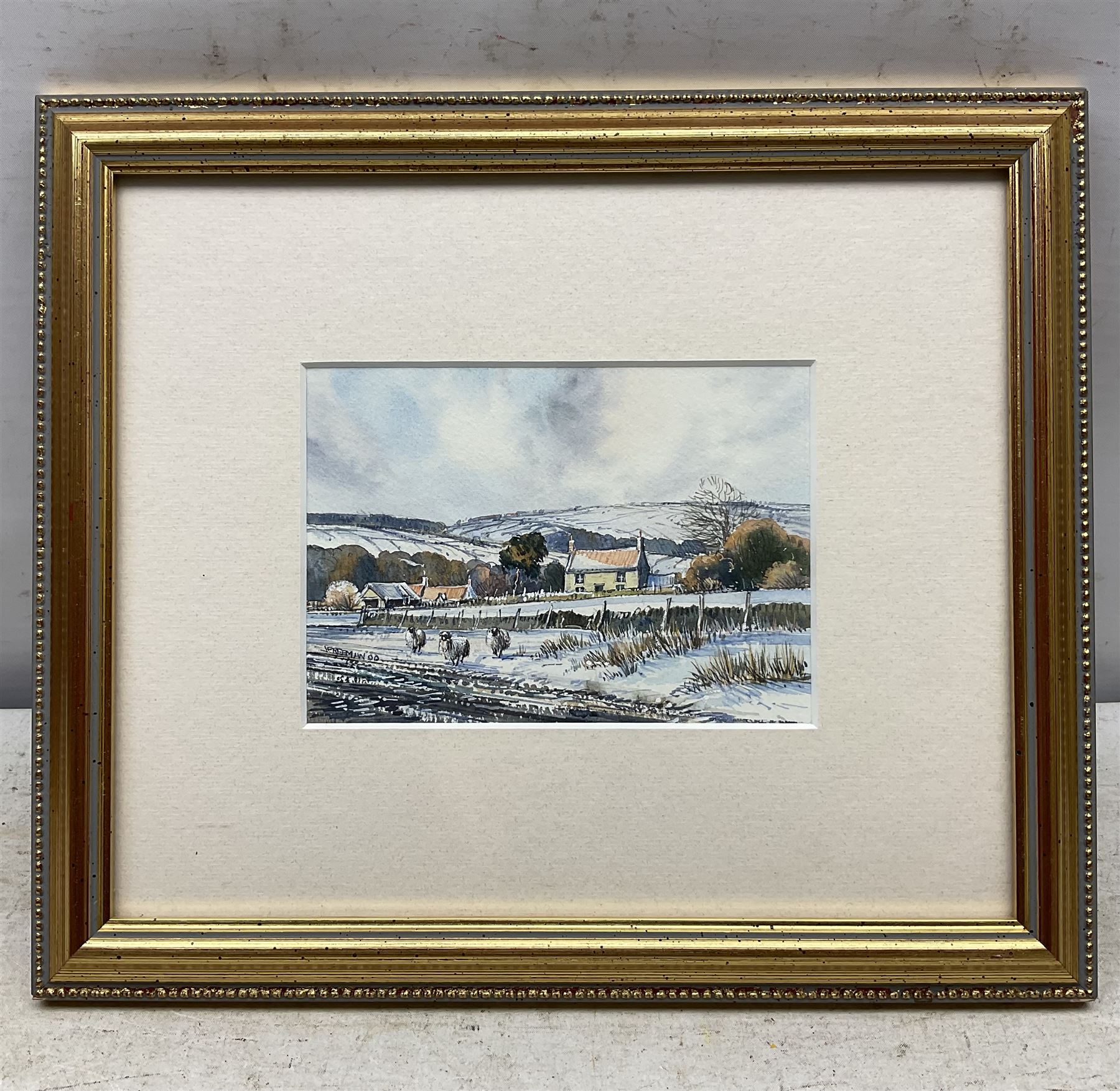 John Freeman (British 1942-): Snow on the Moors, watercolour and ink signed and dated '00, 10cm x 15cm; together with 'Endeavour at Dawn' off Whitby, limited edition print signed and numbered 65/250 in pencil 23cm x 49cm (2)