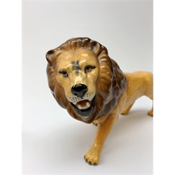 Two Beswick figures, lion, L23cm, H14cm, and cub, L17cm H10cm, each with printed mark beneath. 