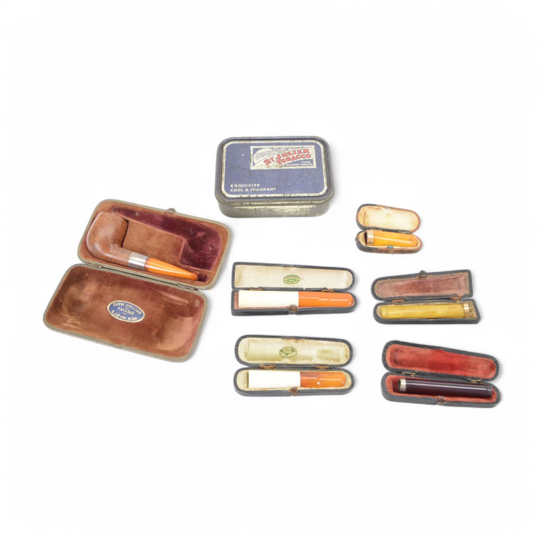 Amber gold mounted cheroot holder, 12.5 ct hallmarked, cased, together with another gold mounted example and various others, and silver mounted pipe 