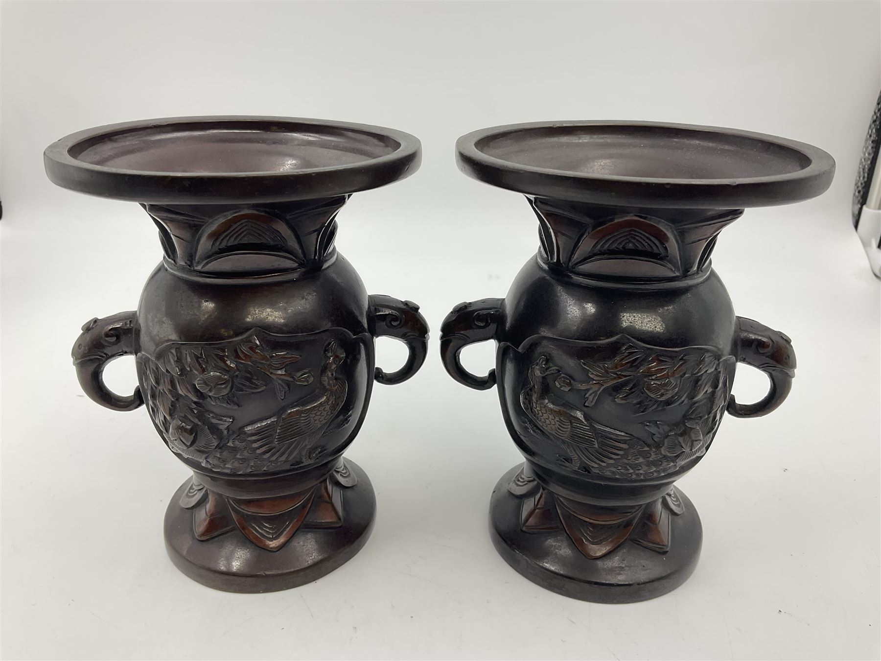 Chinese bronze vase, of baluster form with elongated neck, decorated in relief with birds amongst prunus blossom, together with a smaller pair of twin handled bronzed vases, decorated with peacocks and a blue Peking glass dish, with white metal mounted decorated with dragons, bronze vase H23.3cm