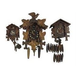 Three 20th century cuckoo clocks and a selection of weights.