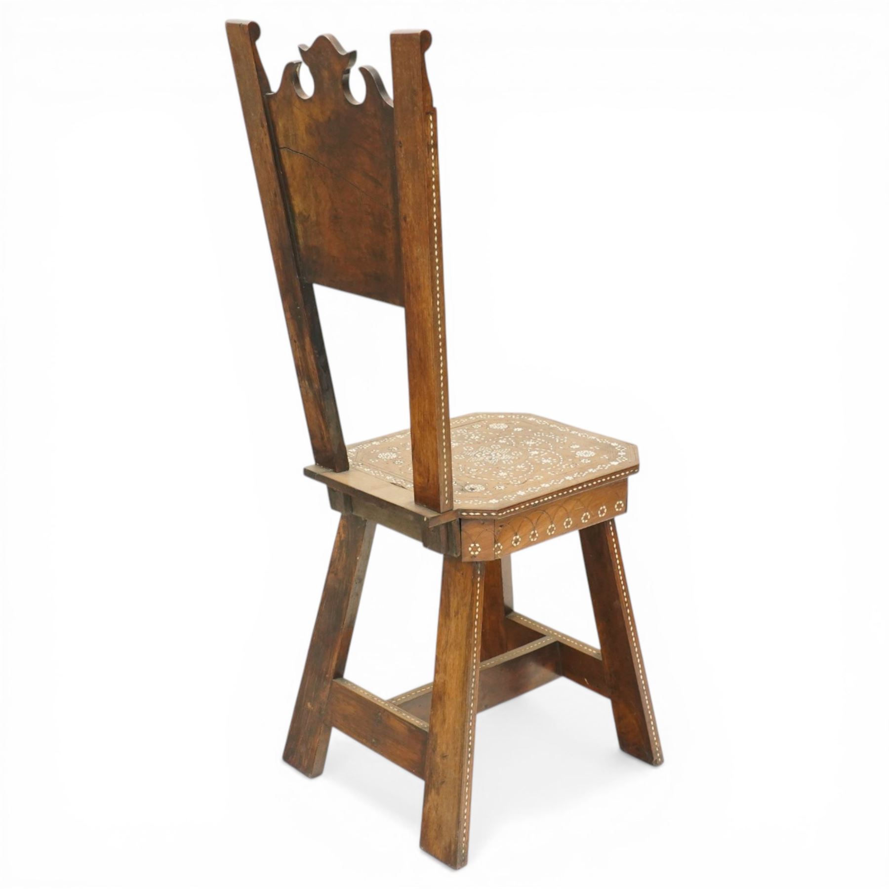 19th century Syrian olive wood and ivory inlaid chair, the shaped back and cresting above a panel centred by a circular starburst roundel within geometric and foliate marquetry and stringing, the tapering uprights and frame extensively inlaid with repeating ivory motifs, the octagonal seat similarly decorated, raised on splayed legs united by H-stretcher with further inlaid ornament