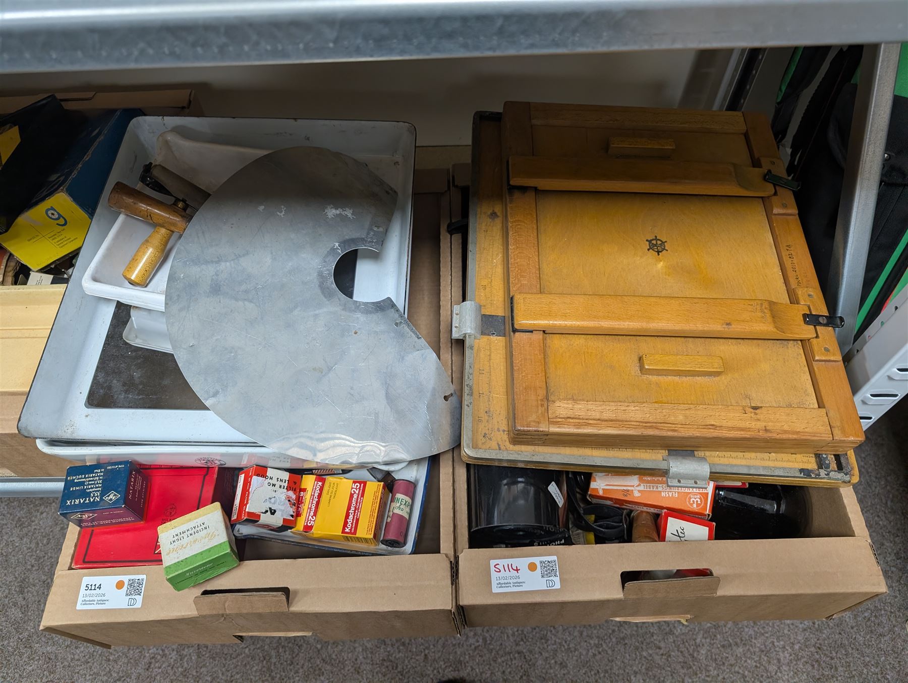 Collection of photography and photograph development accessories, including bulbs, development tanks, trays, projector lenses, etc