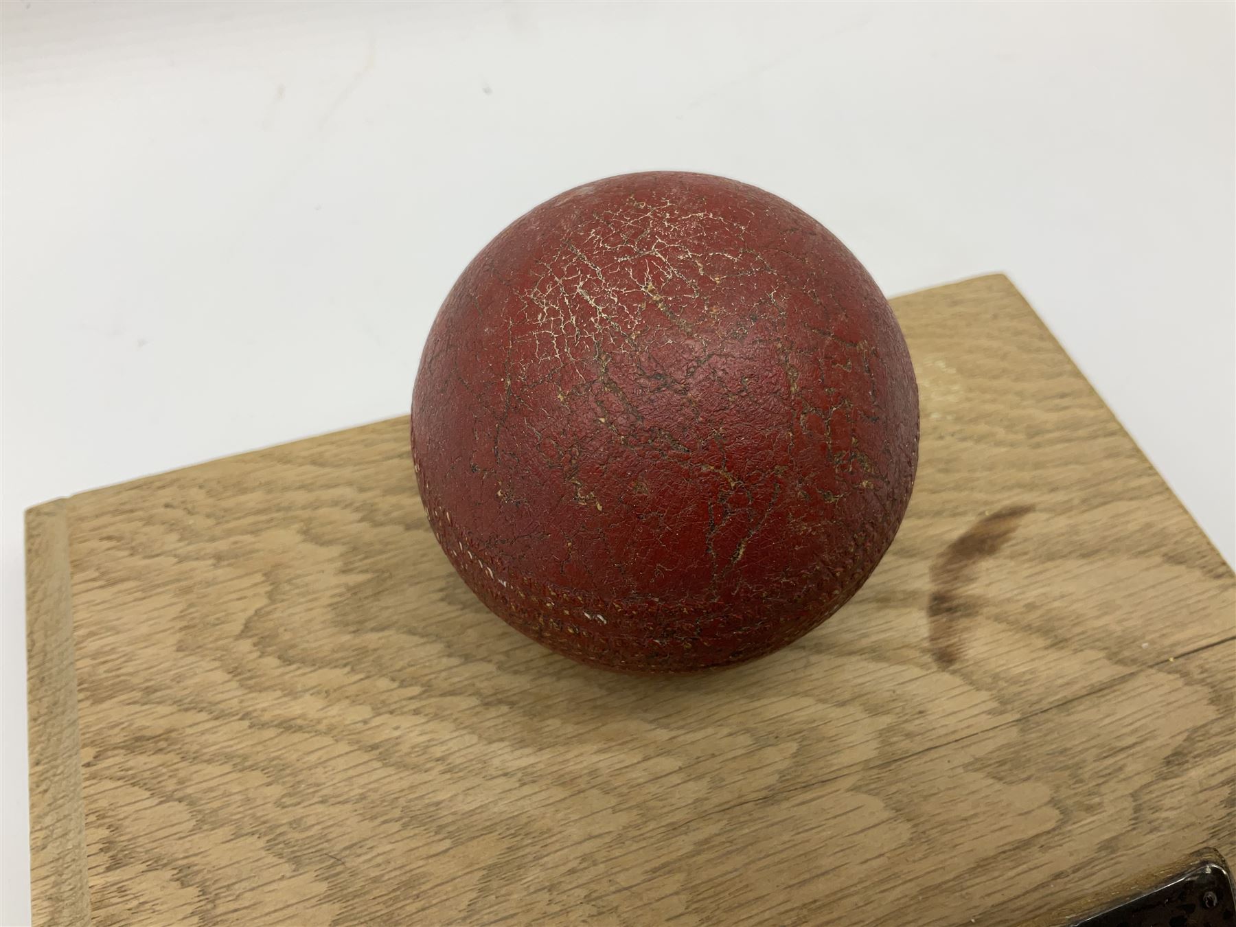 Raich Carter - early school cricket trophy of a cricket ball mounted on an oak base with white metal plaque inscribed 'Swan Cup Final/July 1927/Hendon v Jas.Wms.St/Scores/Hendon 189 for 2 wickets/Jas.Wms.St 55/Carter 111 runs (not out) Four wickets for 21 runs/Hendon School Souvenir/from his Head master G.F. Park' L20cm. Provenance: By direct descent from the family of Raich Carter having been consigned by his daughter Jane Carter.