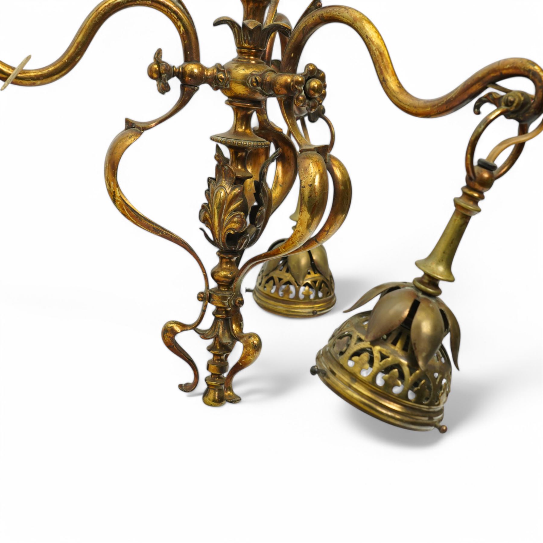 Early 20th century brass three-light chandelier, with Art Nouveau style curved and foliate ornamentation, the hanging branches formed as budding flowers with petal adornments, the bulb holders having pierced decoration to bowls, H43cm; together with two wall sconces